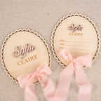 Personalized scalloped oval baby name plaque and matching birth stat plaque with pink ribbon, name Sofia Claire