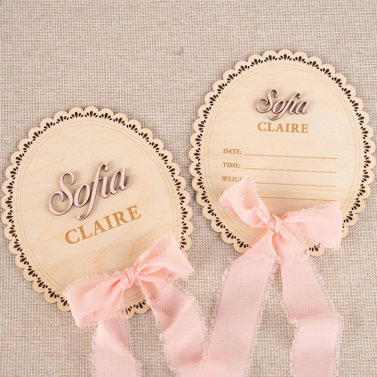Personalized scalloped oval baby name plaque and matching birth stat plaque with pink ribbon, name Sofia Claire