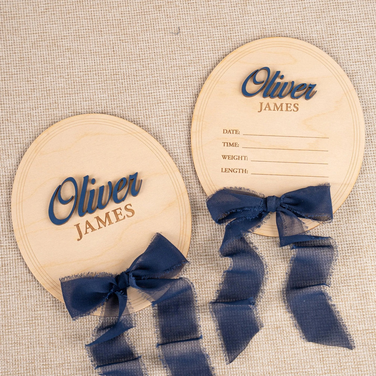 Personalized simple oval baby name plaque and matching birth stat plaque with navy ribbon, name Oliver James