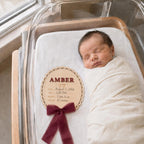 Newborn name sign in a hospital bassinet with the birth stats filled in by hand