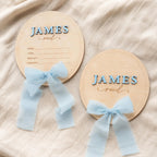 Oval baby name plaque and birth announcement sign with light blue ribbon, name James Reid
