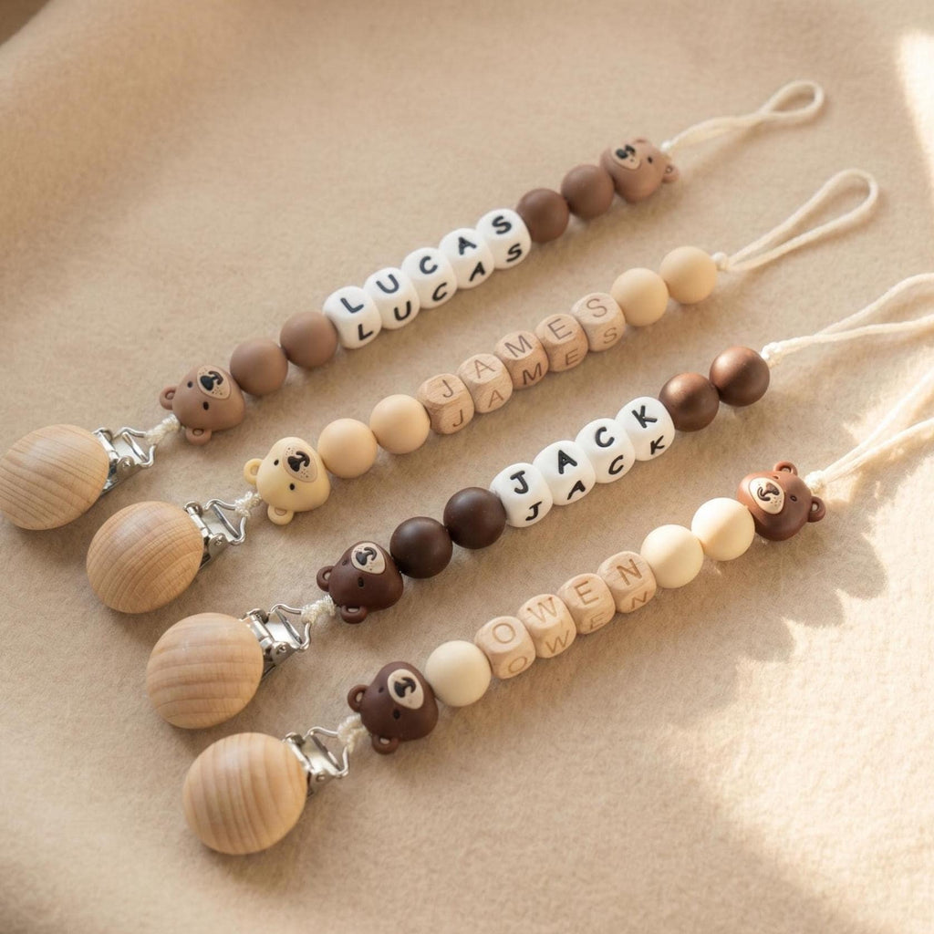 Three personalized teddy bear pacifier clips with boys names in letter beads and brown teddy bear beads